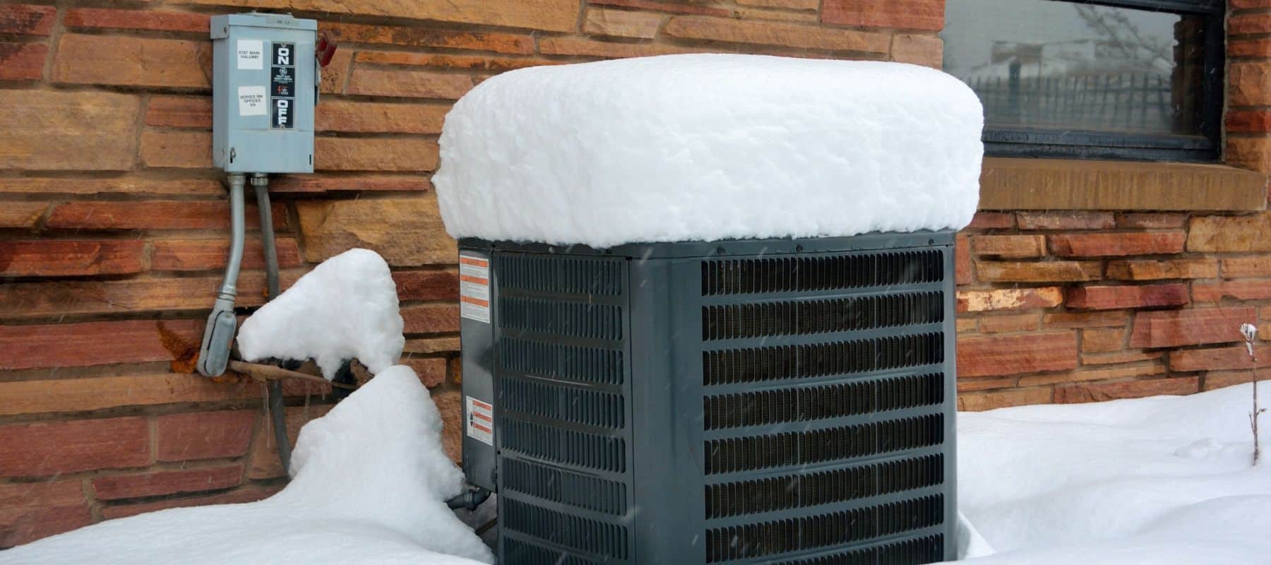 closeup of an outdoor unit covered in snow